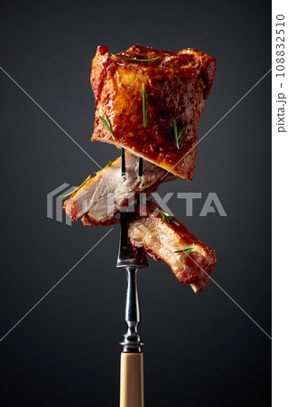 Grilled pork ribs on a fork. Grilled pork ribs on a fork. 108832510