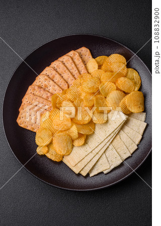 Crispy potato chips with salt, spices and herbs Crispy potato chips with salt, spices and herbs 108832900