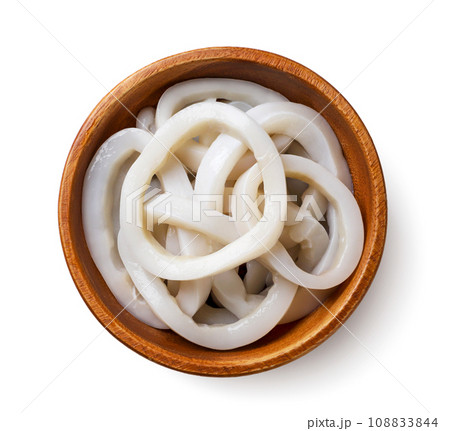 Squid rings in a wooden plate close-up on a white. Top view Squid rings in a wooden plate close-up on a white. Top view 108833844