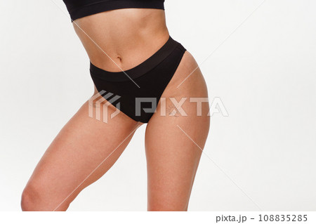 A woman with a beautiful feminine figure in black lingerie with overweight, cellulite and stretch marks. A woman with a beautiful feminine figure in black lingerie with overweight, cellulite and stretch marks. 108835285