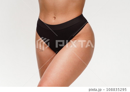 A woman with a beautiful feminine figure in black lingerie with overweight, cellulite and stretch marks. A woman with a beautiful feminine figure in black lingerie with overweight, cellulite and stretch marks. 108835295