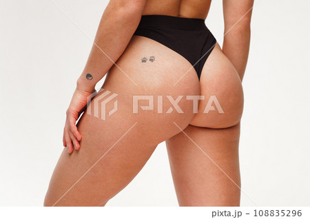 A woman with a beautiful feminine figure in black lingerie with overweight, cellulite and stretch marks. A woman with a beautiful feminine figure in black lingerie with overweight, cellulite and stretch marks. 108835296