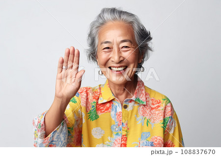 Cheerful asian mature woman smiling and waving hand to say hello, close up, healthy senior lady hand gesture greeting. Generative AI Cheerful asian mature woman smiling and waving hand to say hello, close up, healthy senior lady hand gesture greeting. Generative AI 108837670