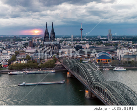 Dramatic storm clouds over Cologne Cathedral and Hohenzollern Bridge in the sunset Dramatic storm clouds over Cologne Cathedral and Hohenzollern Bridge in the sunset 108838191
