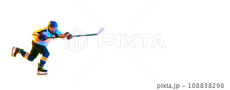 Concentration. Young girl, hockey player in helmet and uniform, training, playing against white background in neon light 108838298
