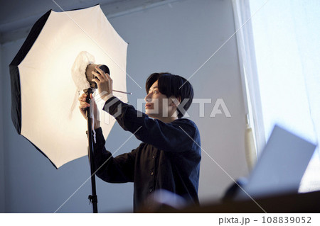 写真スタジオにてストロボの調整を行う日本人フォトグラファーの男性 写真スタジオにてストロボの調整を行う日本人フォトグラファーの男性 108839052