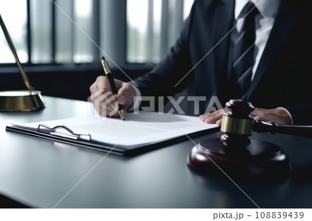 Cropped photo of a lawyer signing documents in court. 108839439