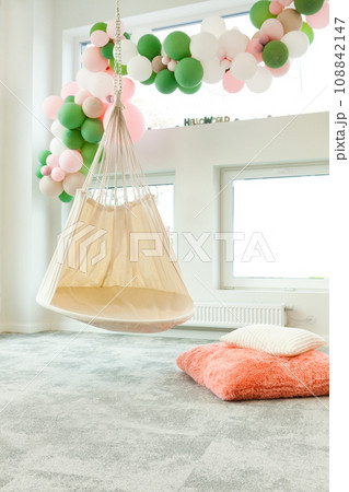 child room with hammock chair and balloons. Colorful kid room with rug, window and chair child room with hammock chair and balloons. Colorful kid room with rug, window and chair 108842147