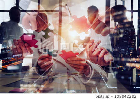 Businessmen working together to build a puzzle as teamwork, partnership and integration concept Businessmen working together to build a puzzle as teamwork, partnership and integration concept 108842282