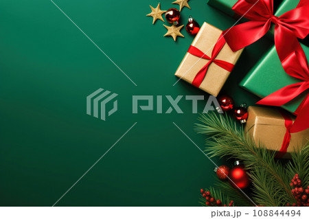 Christmas balls, presents and golden stars on green background 108844494