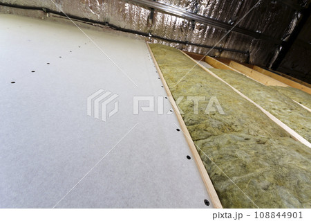 Wooden frame for future walls with drywall plates insulated with rock wool and fiberglass insulation staff for cold barrier. Comfortable warm home, economy, construction and renovation concept. 108844901