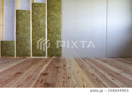 Wooden frame for future walls with drywall plates insulated with rock wool and fiberglass insulation staff for cold barrier. Comfortable warm home, economy, construction and renovation concept. 108844903