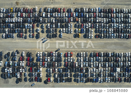 View from above of big parking lot with parked used cars after accident ready for sale. Auction reseller company selling secondhand broken vehicles for repair View from above of big parking lot with parked used cars after accident ready for sale. Auction reseller company selling secondhand broken vehicles for repair 108845080