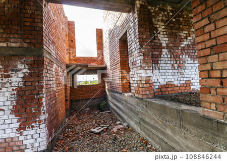Interior of an old building under construction. Orange brick walls in a new house. Interior of an old building under construction. Orange brick walls in a new house. 108846244