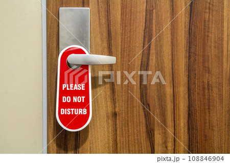 Door of hotel room with sign please do not disturb. Door of hotel room with sign please do not disturb. 108846904
