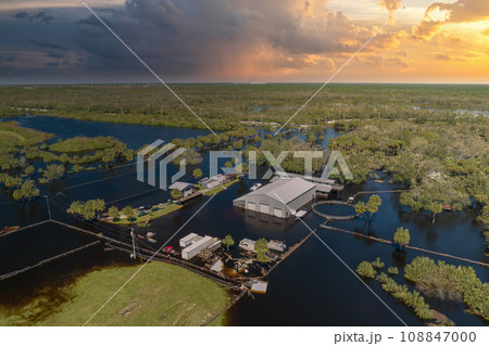 Consequences of natural disaster. Flooded industrial business warehouse by hurricane Ian rainfall in Florida rural area 108847000