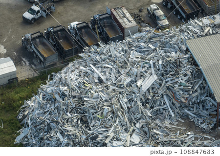 Beg pile of scrap aluminum metal siding from ruined houses after hurricane Ian swept through Florida. Recycle of broken parts of mobile homes 108847683