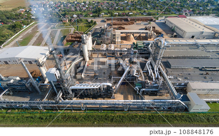 Aerial view of oil and gas refining petrochemical factory with tall refinery plant manufacture structure. Aerial view of oil and gas refining petrochemical factory with tall refinery plant manufacture structure. 108848176