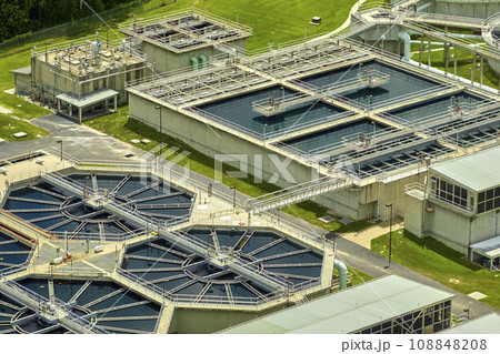 Aerial view of modern water cleaning facility at urban wastewater treatment plant. Purification process of removing undesirable chemicals, suspended solids and gases from contaminated liquid Aerial view of modern water cleaning facility at urban wastewater treatment plant. Purification process of removing undesirable chemicals, suspended solids and gases from contaminated liquid 108848208