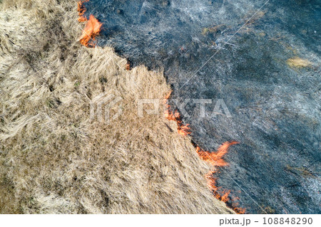 Aerial view of grassland field burning with red fire during dry season. Natural disaster and climate change concept 108848290