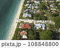 Wealthy neighborhood in small town Boca Grande, Florida with expensive waterfront houses between green palm trees. Development of US premium housing 108848800