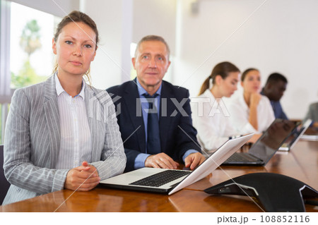 Portrait of mid aged white business woman posing at camera during meeting Portrait of mid aged white business woman posing at camera during meeting 108852116