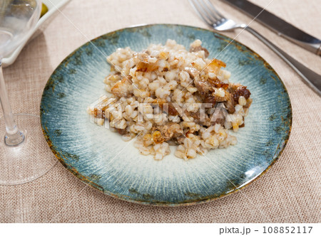 Nice tasty barley porridge served with lard mixed in 108852117