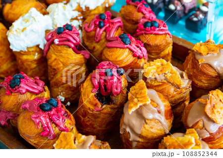 Sweet cruffins from yeast puff pastry with different toppings Sweet cruffins from yeast puff pastry with different toppings 108852344