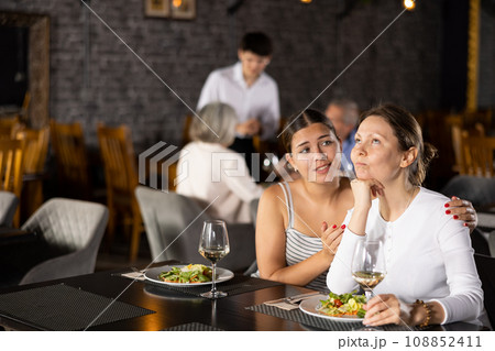 Sad upset young woman shares with female friend about difficult period of relations with boyfriend 108852411