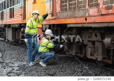 engineer team service maintenance old broken diesel train park at railway depot team working with safety suit. engineer team service maintenance old broken diesel train park at railway depot team working with safety suit. 108855148