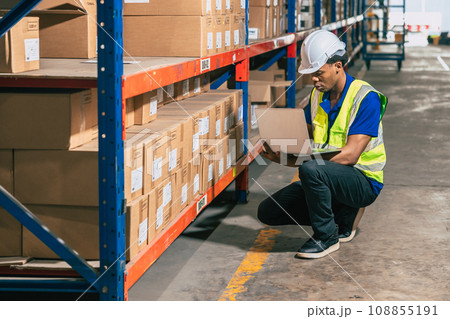 warehouse african black male worker. inventory clerk staff stock employee work in cargo storage shelf check remaining products order for shipping. 108855191
