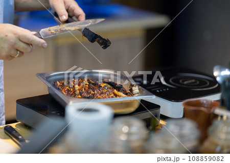 Chef plating a dish in the kitchen Chef plating a dish in the kitchen 108859082