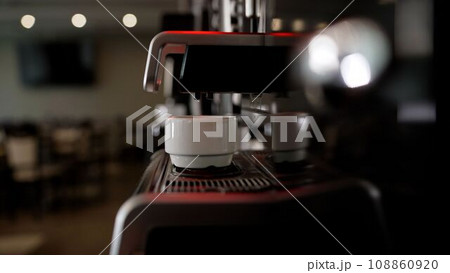 Americano preparation process. Espresso from a coffee machine. Coffee machine at the hotel buffet. Coffee machines make coffee without people. The coffee machine pours coffee into a glass. 108860920