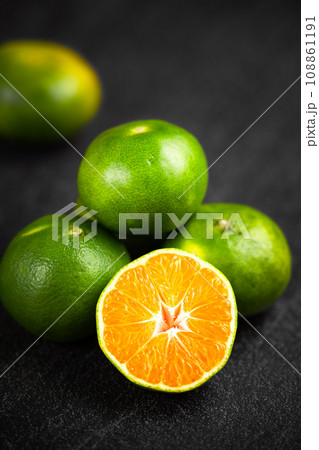 Oranges placed on a black marble slab. Oranges placed on a black marble slab. 108861191