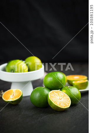 Oranges placed on a black marble slab. Oranges placed on a black marble slab. 108861195