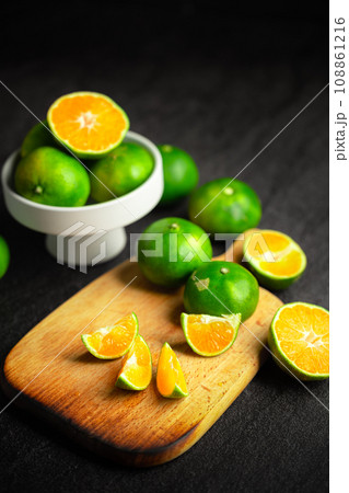 Oranges placed on a black marble slab. Oranges placed on a black marble slab. 108861216