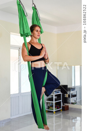 Young woman making aerial or fly yoga pose 108862522