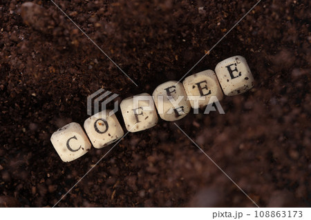 Coffee alphabet letter word bead fly with powder seed. Coffee roasted concept to refresh morning work. Coffee mix bean dust powder, alphabet letter word concept. Black background isolated 108863173