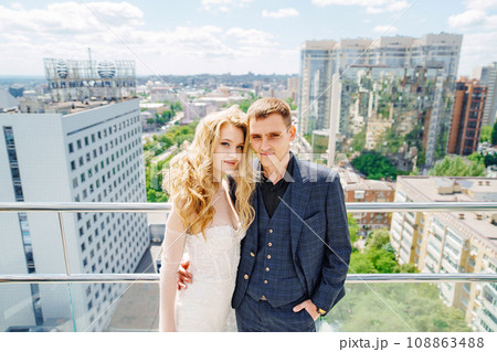 Happy bride and groom on the terrace of a multi-storey hotel. Happy bride and groom on the terrace of a multi-storey hotel. 108863488