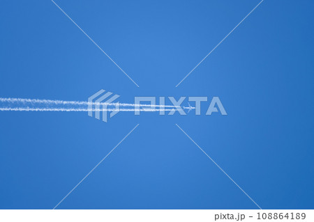 Condensation trail from an airplane in a blue sky 108864189