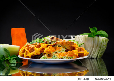 cooked two-color vegetable waffles made from cabbage and carrots. 108865824