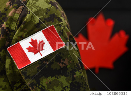Canada Day. Flag of Canada on the military uniform and red Maple leaf on the background. Canadian soldiers. Army of Canada. Canada leaf. Remembrance Day. Poppy day. Canada Day. Flag of Canada on the military uniform and red Maple leaf on the background. Canadian soldiers. Army of Canada. Canada leaf. Remembrance Day. Poppy day. 108866333