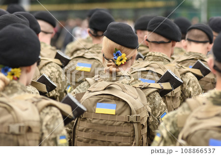 Woman soldier. Woman in army. Ukrainian flag on military uniform. Ukraine troops. 108866537