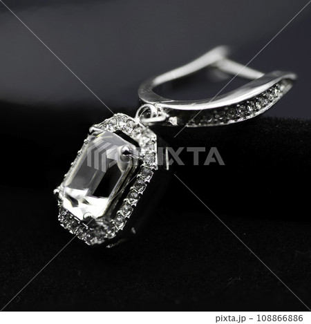 Close up macro photography, swan and octagon diamond earring and necklace jewelry set of cloth black background. Close up macro photography, swan and octagon diamond earring and necklace jewelry set of cloth black background. 108866886