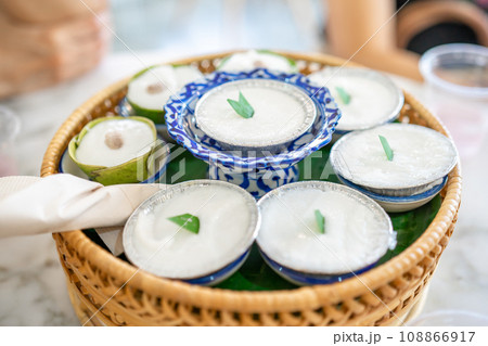 Luxury Dessert, Khanom thuai is Thai dessert coconut milk pudding was arranged in the wicker set on the marble table. 108866917