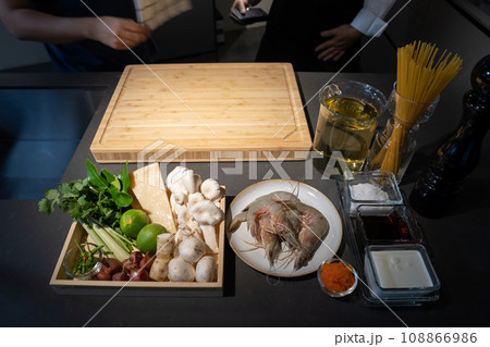 Focused on Shrimp in among of ingredients, lime, mushroom, shallot, lemon grass, spring onion, chilli, tobiko, bergamot, cheese and spaghetti meal cooking. Focused on Shrimp in among of ingredients, lime, mushroom, shallot, lemon grass, spring onion, chilli, tobiko, bergamot, cheese and spaghetti meal cooking. 108866986