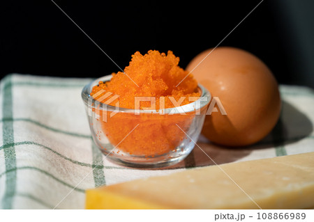 Focused on fresh Tobiko, flying fish roe with blur egg beside it. Focused on fresh Tobiko, flying fish roe with blur egg beside it. 108866989