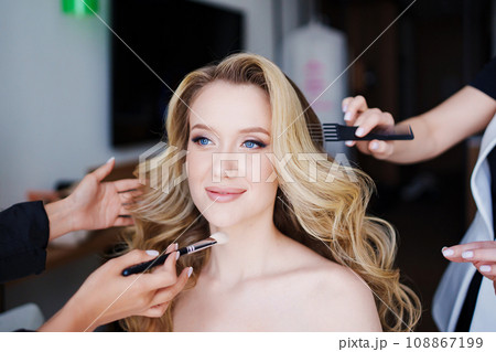 Morning of the bride. Make-up and hair styling for the bride on the wedding day. 108867199