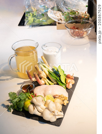 An ingredients set of famous thai soup. The ingredients can be bought at the market, chicken, vegetable, coconut cream, stock soup, herbs together combine as a great dish. An ingredients set of famous thai soup. The ingredients can be bought at the market, chicken, vegetable, coconut cream, stock soup, herbs together combine as a great dish. 108867629