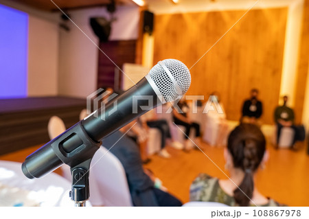 microphone is on microphone stand in seminar meeting room for everyone to use when speaking or greeting seminar participants. microphone is on microphone stand in seminar meeting room for everyone to use when speaking or greeting seminar participants. 108867978